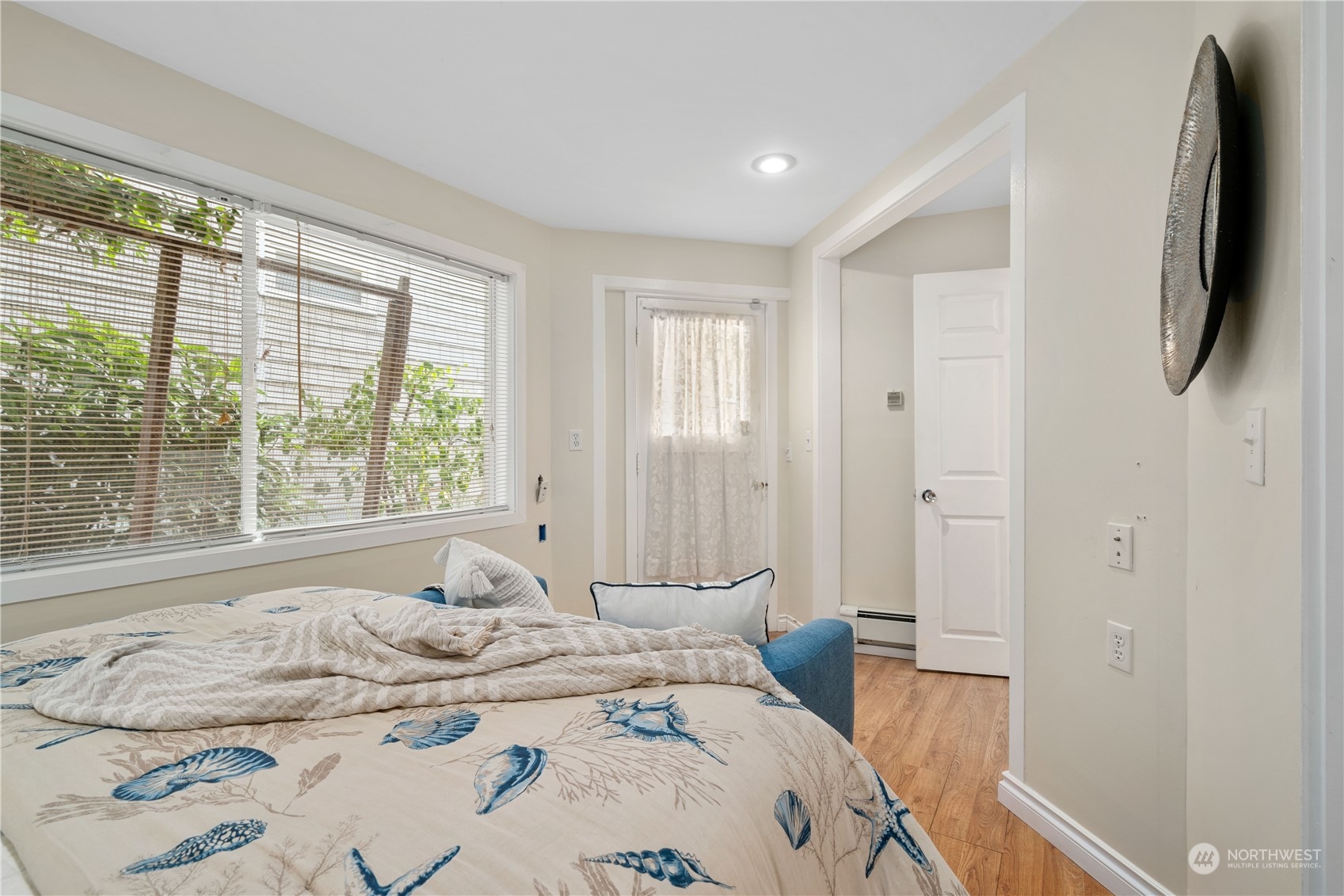 7127 Beach Drive Southwest Seattle, WA 98136 - Photo 29 of 33 a bedroom with a bed and a large window