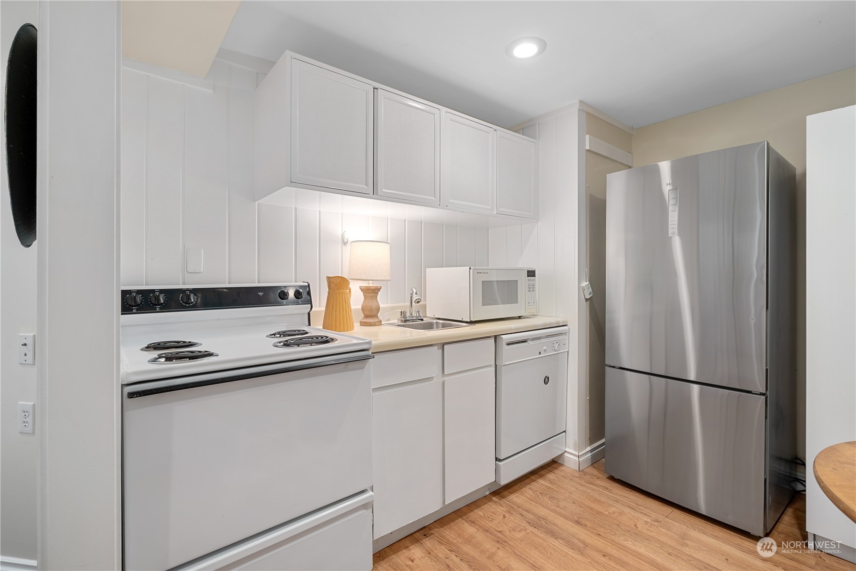 7127 Beach Drive Southwest Seattle, WA 98136 - Photo 30 of 33 a kitchen with stainless steel appliances granite countertop a refrigerator and a sink