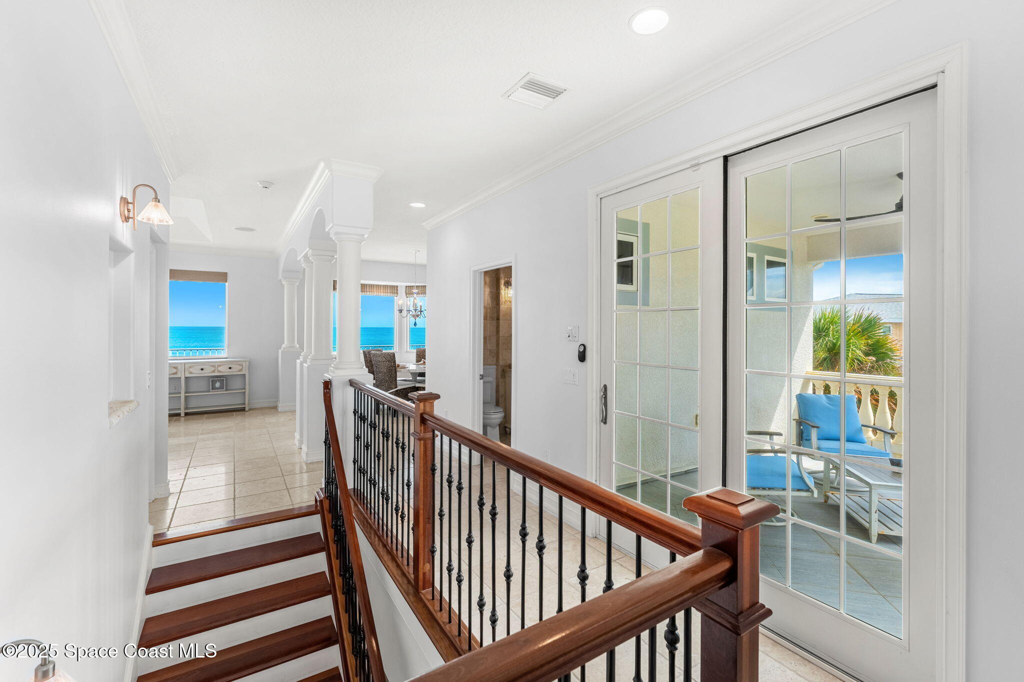 5795 Florida A1A Melbourne Beach, FL 32951 - Photo 24 of 71 a view of a hallway with wooden floor and stairs