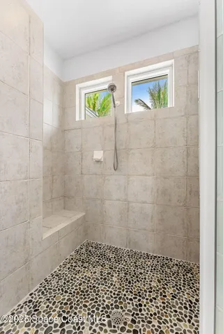 a bathroom with a granite countertop sink a toilet and a mirror