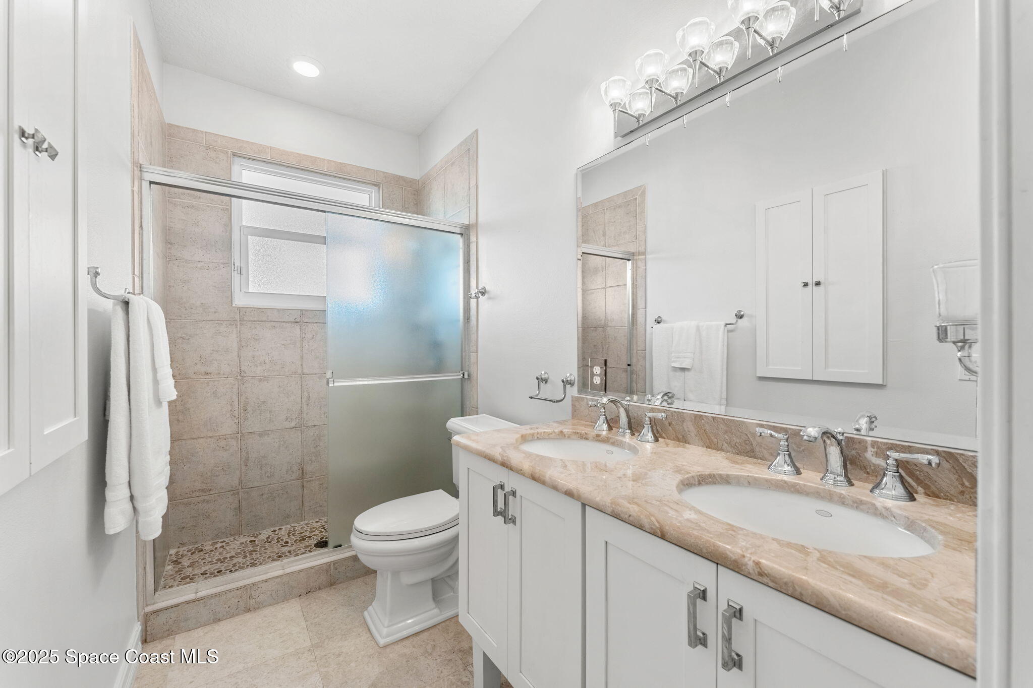 5795 Florida A1A Melbourne Beach, FL 32951 - Photo 34 of 71 a bathroom with a granite countertop sink a toilet and shower