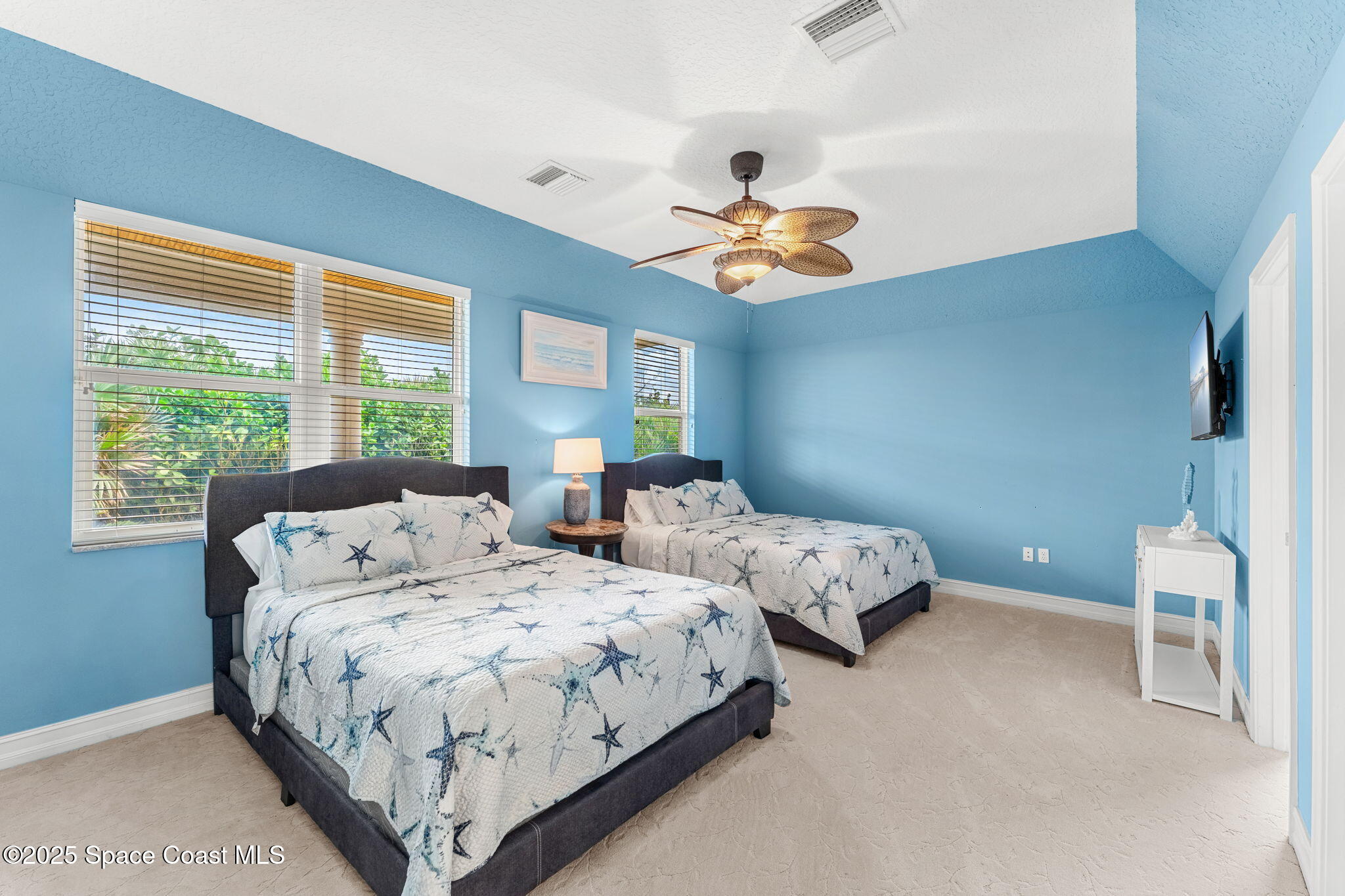 5795 Florida A1A Melbourne Beach, FL 32951 - Photo 38 of 71 a bedroom with two large bed and a large window