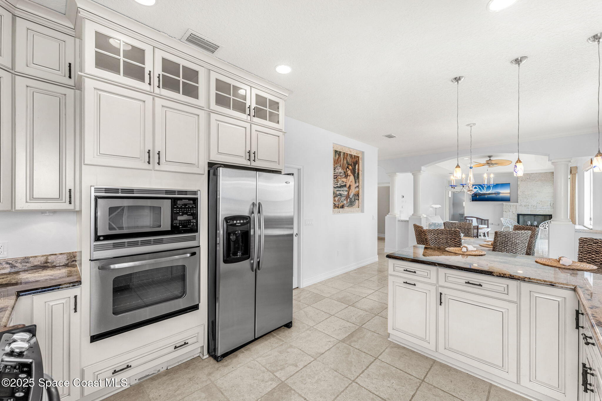 5795 Florida A1A Melbourne Beach, FL 32951 - Photo 46 of 71 a kitchen with stainless steel appliances granite countertop a sink a stove and a refrigerator