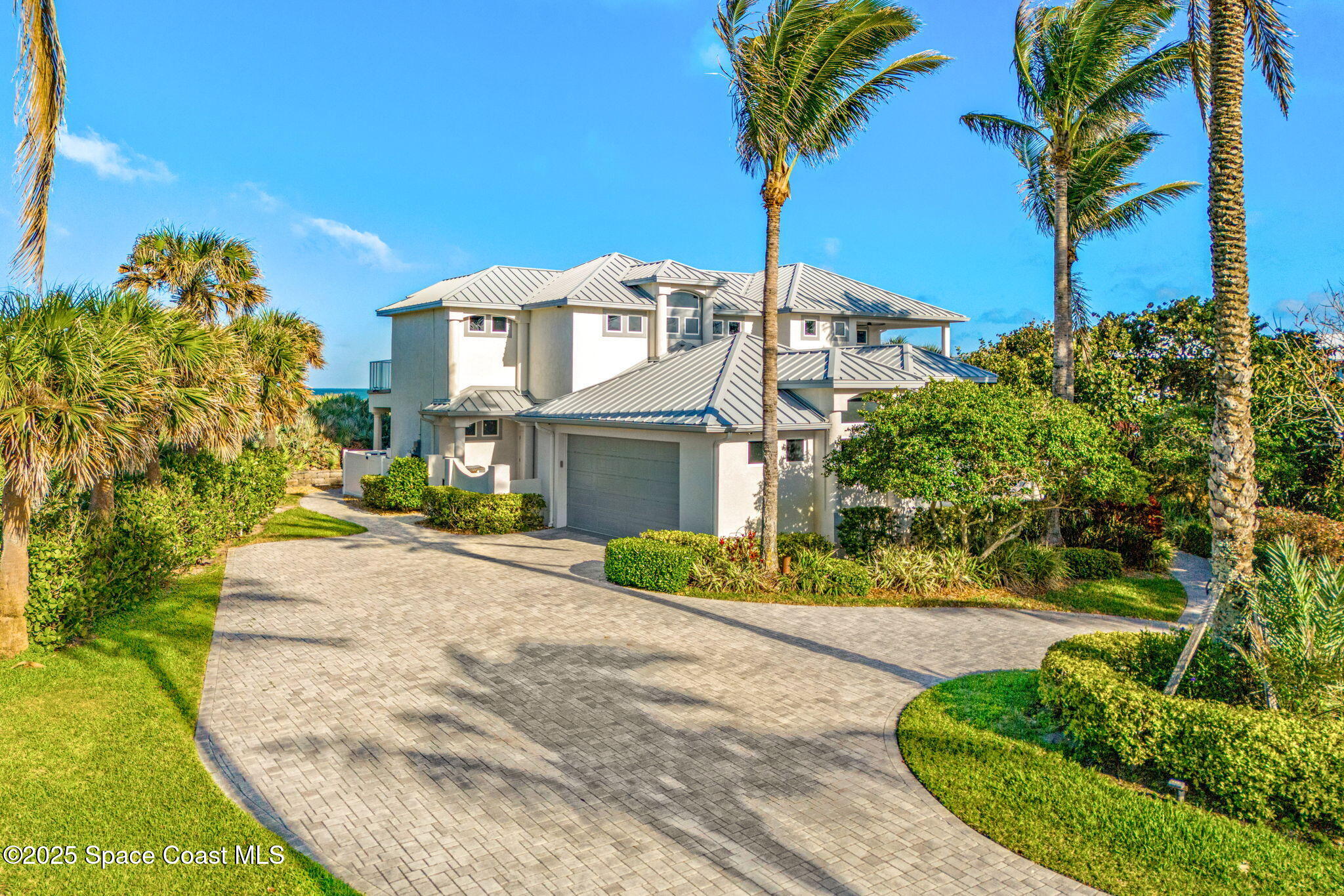 5795 Florida A1A Melbourne Beach, FL 32951 - Photo 70 of 71 a front view of a house with a yard and garage