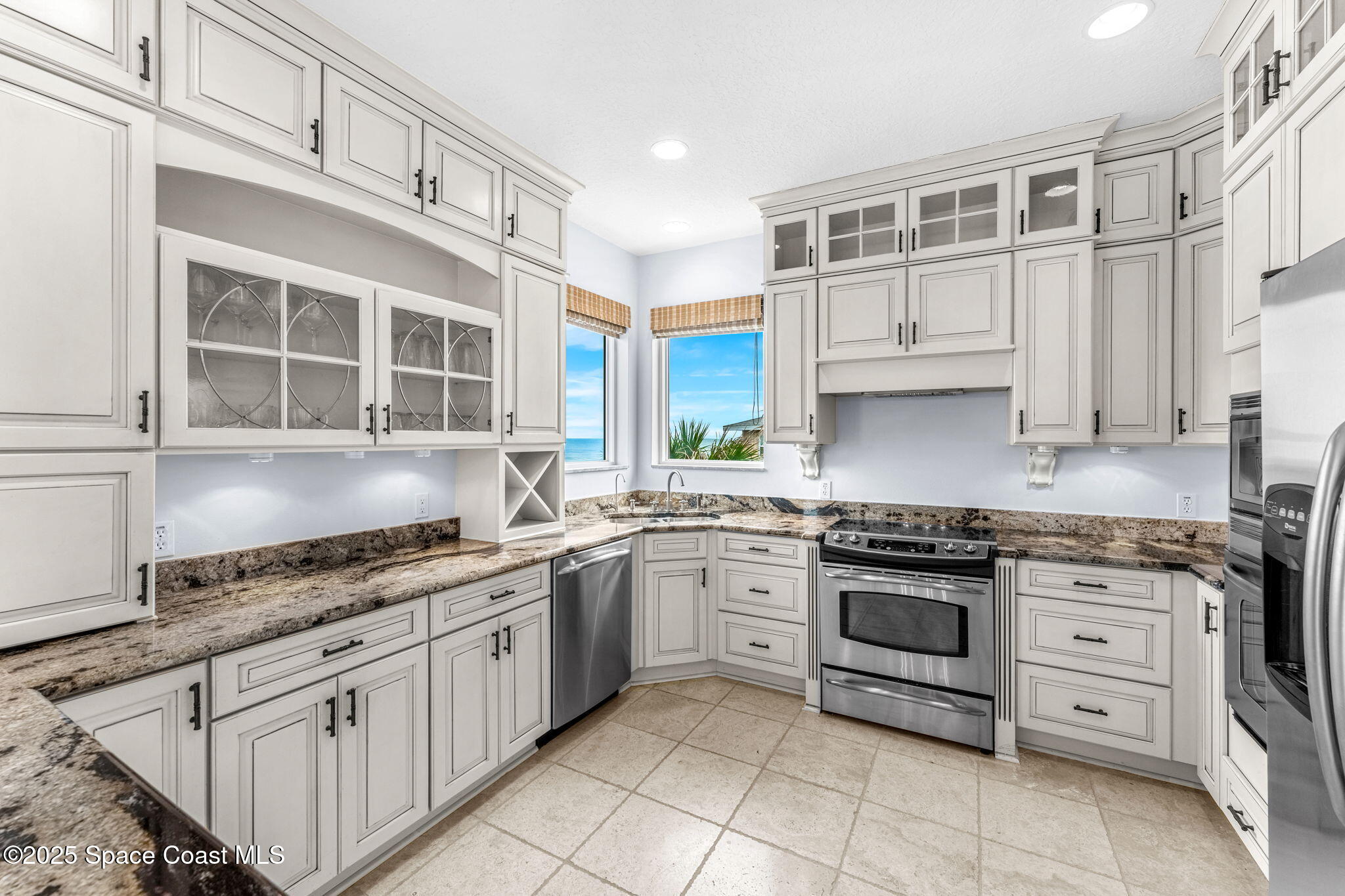 5795 Florida A1A Melbourne Beach, FL 32951 - Photo 7 of 71 a kitchen with stainless steel appliances granite countertop a stove sink and cabinets