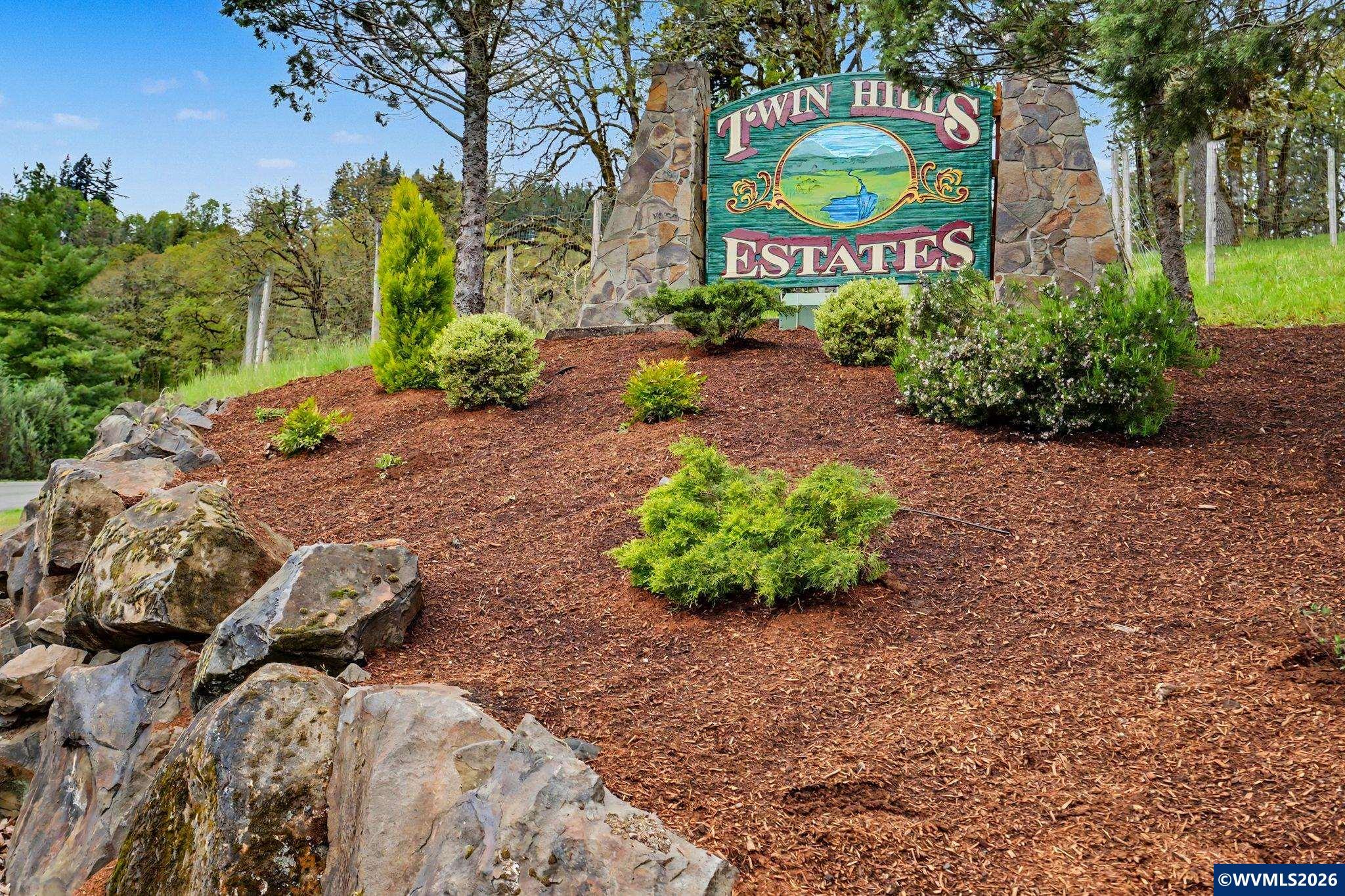 1299 Twin Hills Road Southeast Jefferson, OR 97352 - Photo 2 of 47 a sign that is in front of flowers