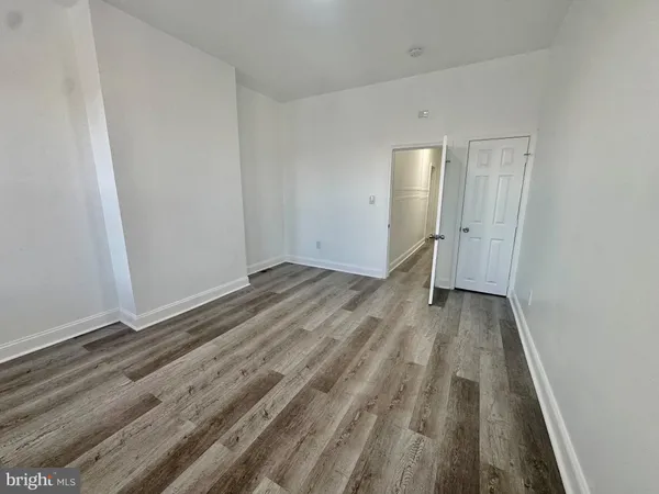 a view of room with wooden floor