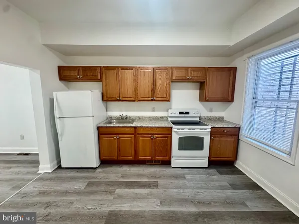 a kitchen with a refrigerator and a stove