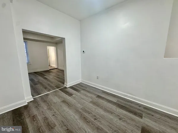 an empty room with wooden floor and closet