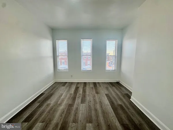 an empty room with wooden floor