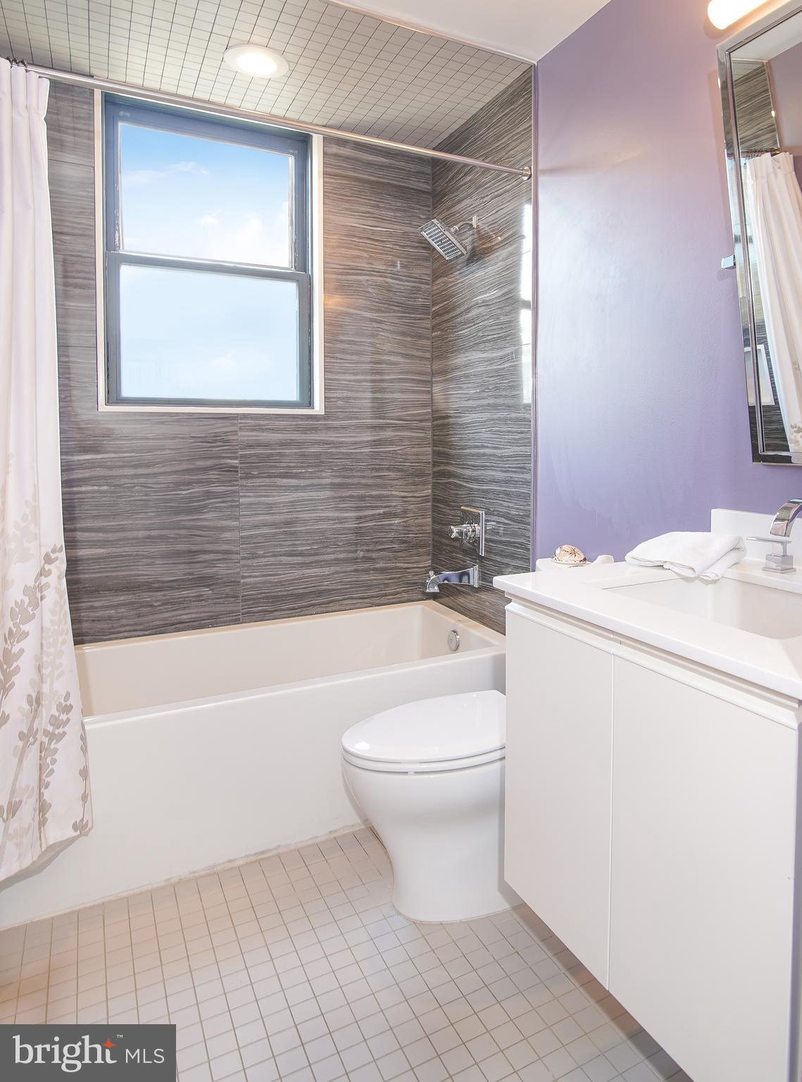1012 Harvard Street Northwest, Unit 8 Washington, DC 20001 - Photo 13 of 34 a bathroom with a toilet a sink and bathtub