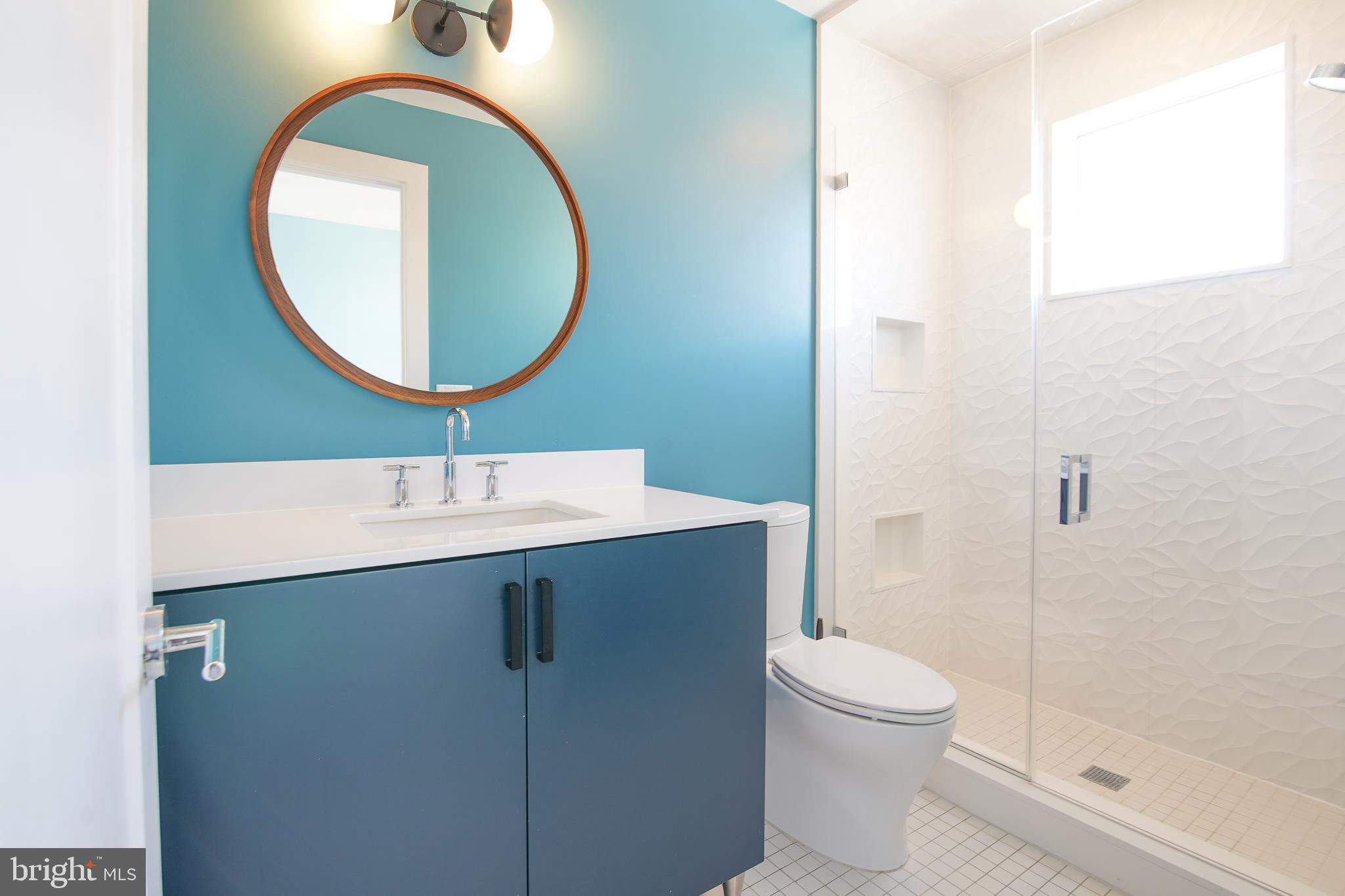 1012 Harvard Street Northwest, Unit 8 Washington, DC 20001 - Photo 27 of 34 a bathroom with a sink mirror and toilet