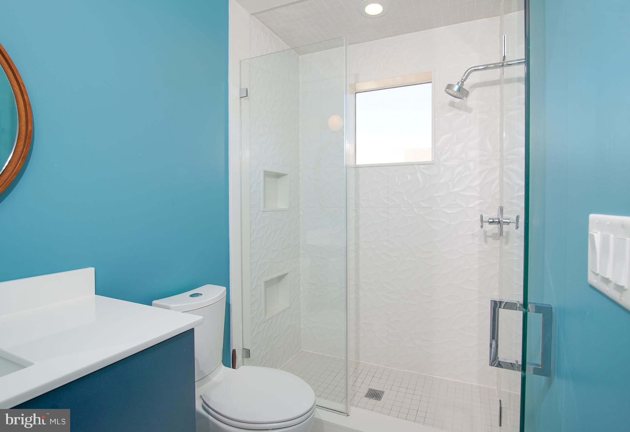 1012 Harvard Street Northwest, Unit 8 Washington, DC 20001 - Photo 28 of 34 a bathroom with a toilet a sink and shower