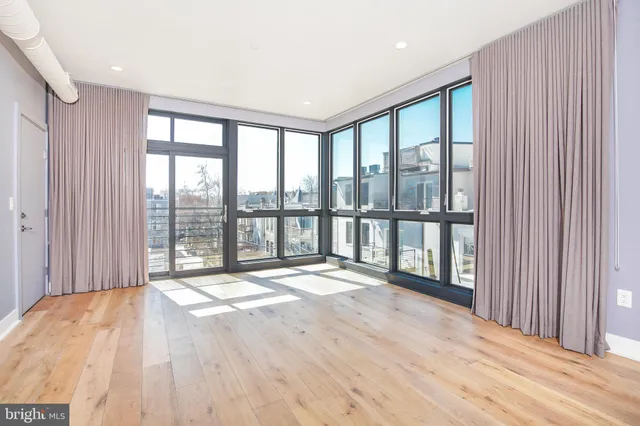 a view of an empty room and a window