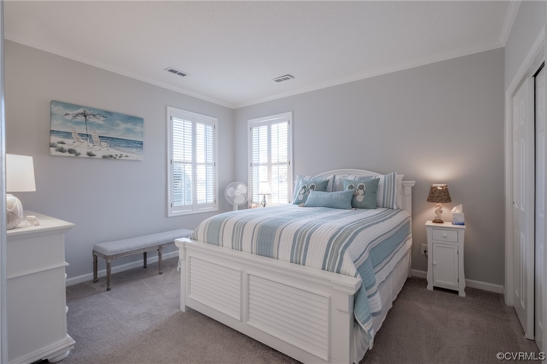 1003 High Dunes Quay, Unit 101 Hampton, VA 23664 - Photo 36 of 42 a bedroom with a bed and a table