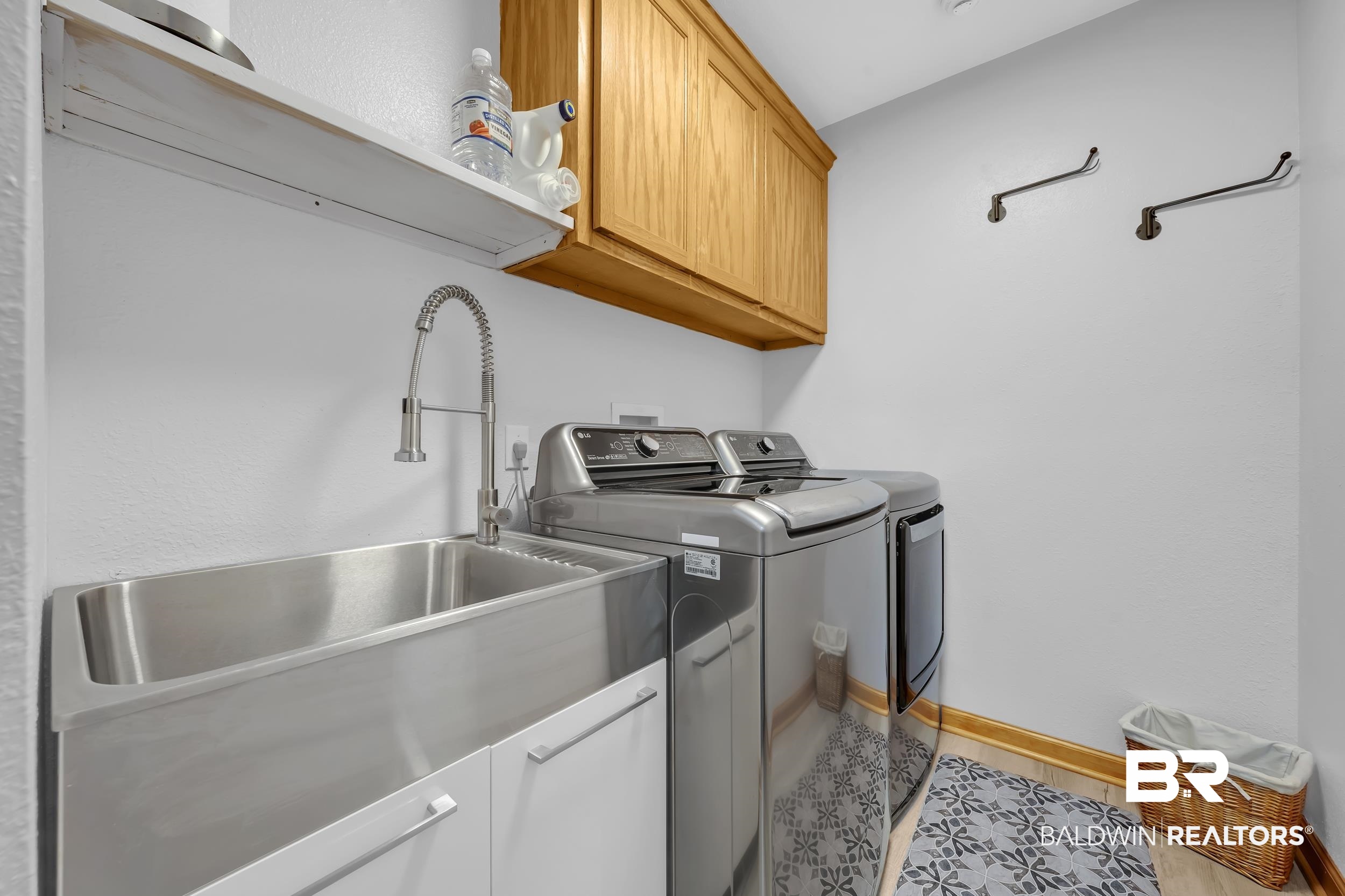 22929 Highway 98 Foley, AL 36535 - Photo 27 of 54 Laundry room featuring cabinet space, washing machine and clothes dryer, and light wood-style flooring