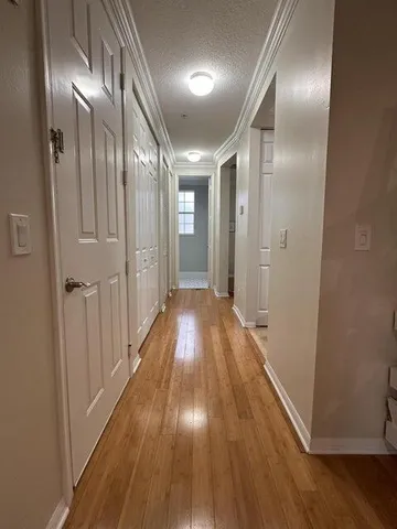 a view of hallway with wooden floor