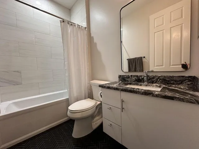 a bathroom with a sink a toilet and a mirror