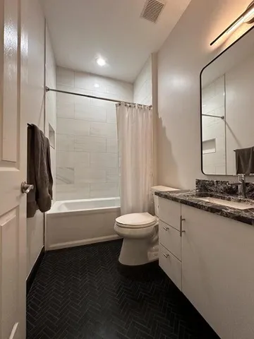 a bathroom with a sink a toilet and a large mirror