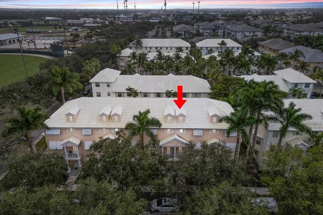 an aerial view of a house with garden space and street view