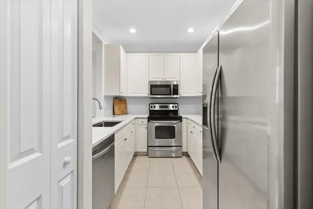 a kitchen with a refrigerator and cabinets
