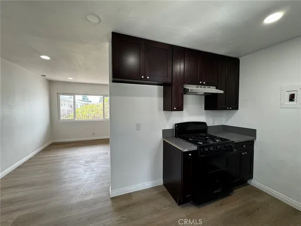 a kitchen with a stove and a refrigerator
