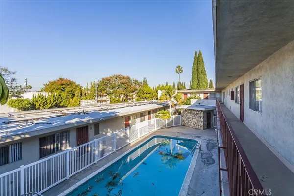 a view of a balcony with two chairs and a table