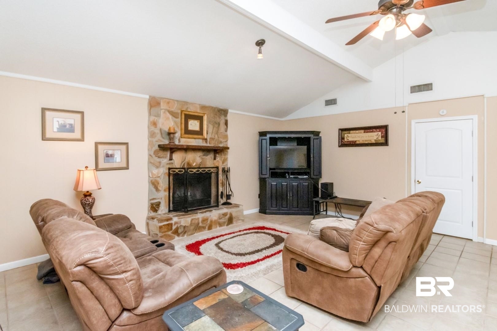 1321 Rainbow Drive West Mobile, AL 36693 - Photo 17 of 48 Tiled living room featuring vaulted ceiling with beams, a stone fireplace, and ceiling fan