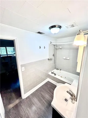 a bath room with a sink and a mirror