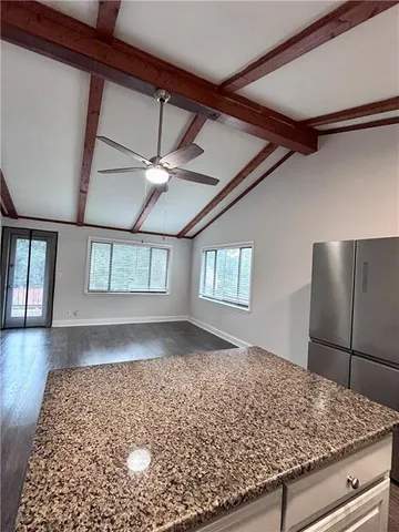 a view of a hallway with a window and wooden floor