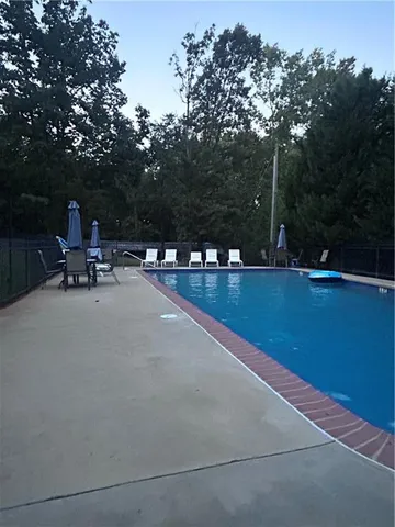 a view of swimming pool with chairs