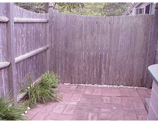 82 Lower County Road, Unit 2 Dennis, MA 02639 - Photo 6 of 7 a view of a wooden fence