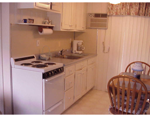 82 Lower County Road, Unit 2 Dennis, MA 02639 - Photo 7 of 7 a kitchen with stainless steel appliances granite countertop a stove a sink and a refrigerator