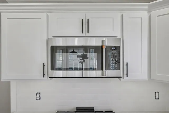 a white cabinet with a hallway