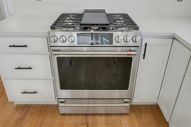 a stove top oven sitting inside of a kitchen