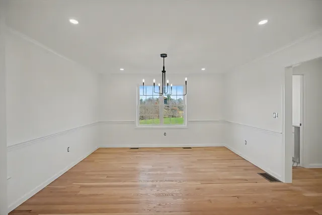 a view of room with window and wooden floor