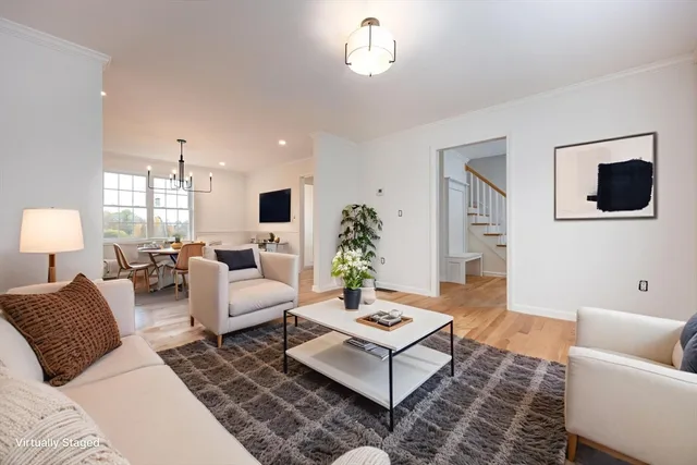 a living room with furniture a rug and a flat screen tv