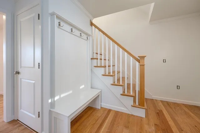 a view of entryway with wooden floor and stairs