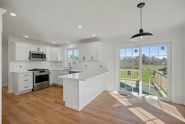 a kitchen with stainless steel appliances a stove top oven and a sink