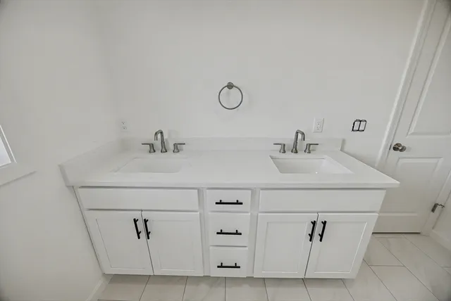 a bathroom with a sink and cabinets