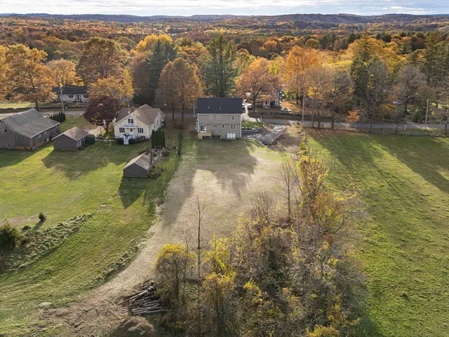 an aerial view of residential houses with outdoor space