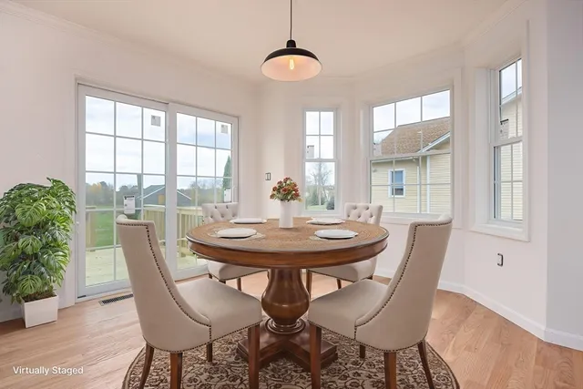 a view of a dining room with furniture window and wooden floor