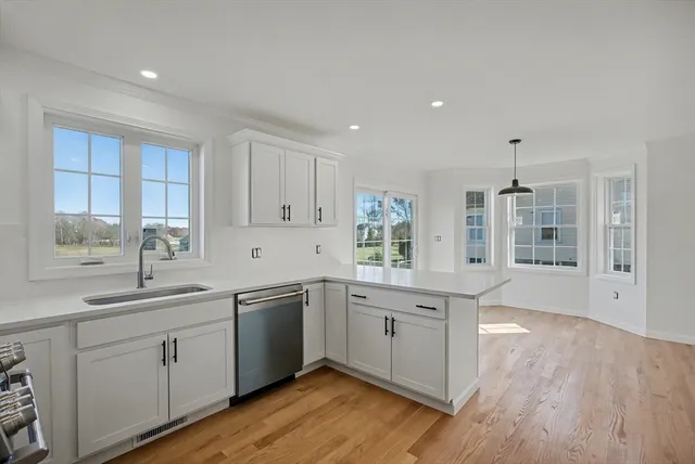 a kitchen with sink cabinets and wooden floor