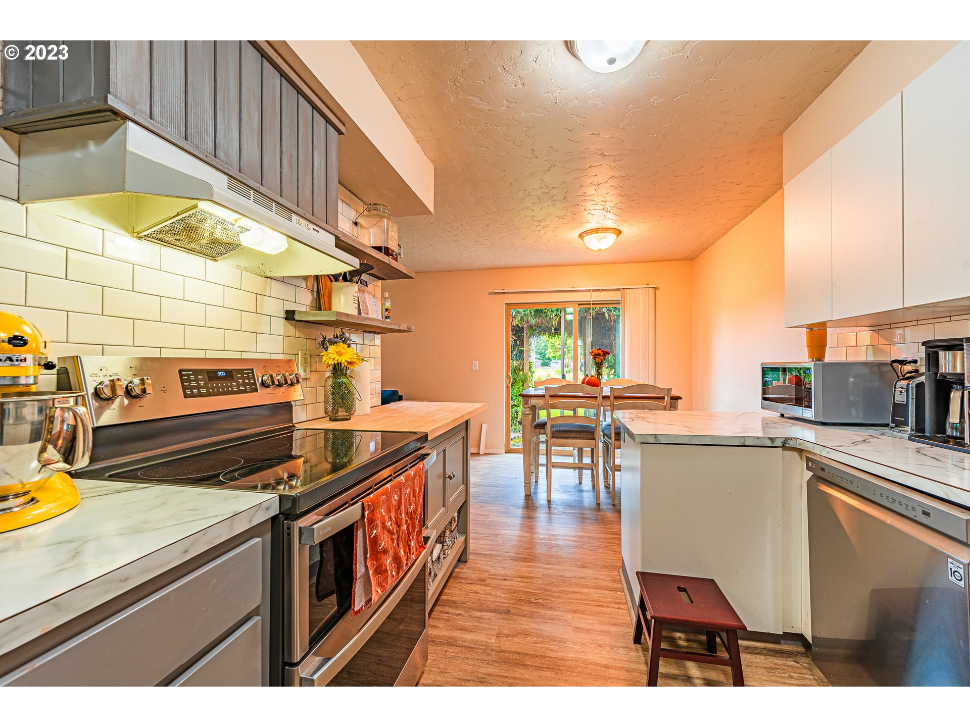 2727 Gateway Street, Unit 48 Springfield, OR 97477 - Photo 11 of 25 a open kitchen with stainless steel appliances granite countertop a stove and a wooden cabinets