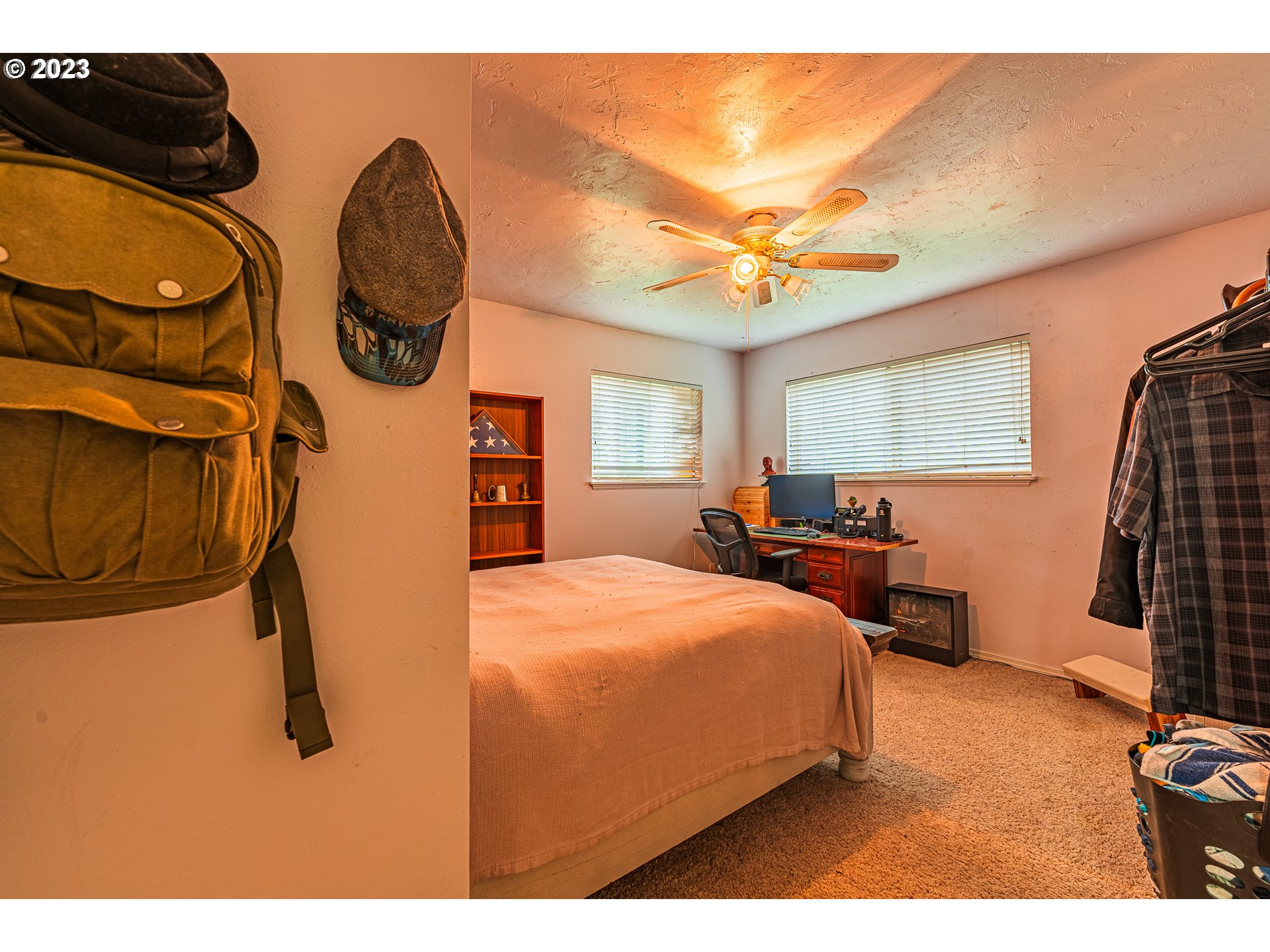 2727 Gateway Street, Unit 48 Springfield, OR 97477 - Photo 19 of 25 a bedroom with a bed a dresser and potted plants with wooden floor