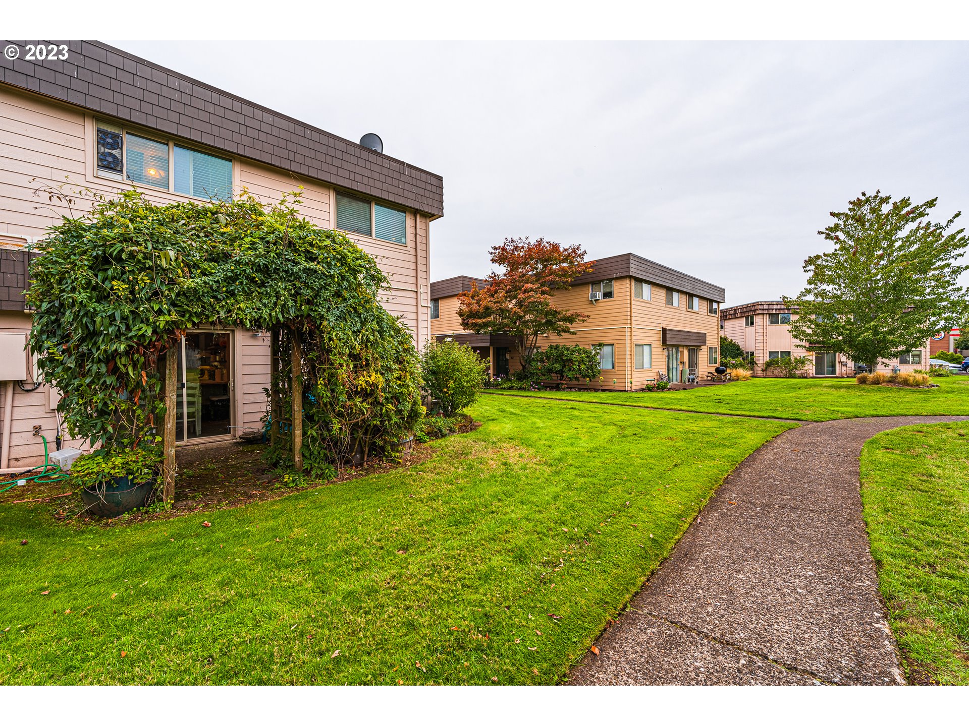 2727 Gateway Street, Unit 48 Springfield, OR 97477 - Photo 25 of 25 a view of a house with a big yard and potted plants
