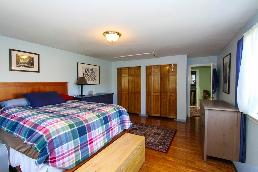 41 Leland Farm Road, Unit 41 Ashland, MA 01721 - Photo 7 of 9 a bedroom with a bed and wooden floor