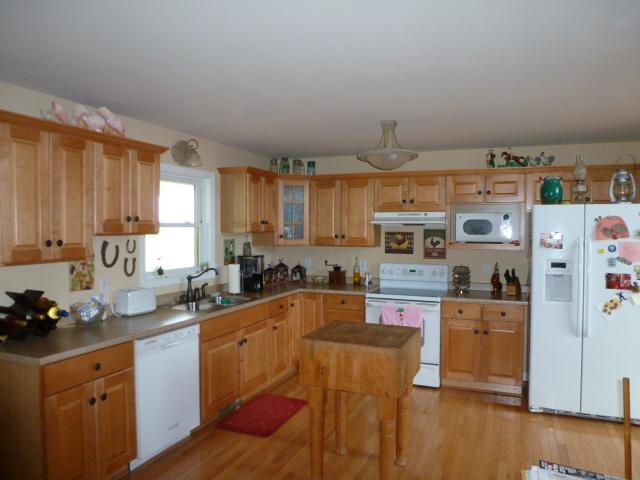 3900 McGregor Road Adams, TN 37010 - Photo 7 of 20 a kitchen with stainless steel appliances granite countertop a sink stove and refrigerator
