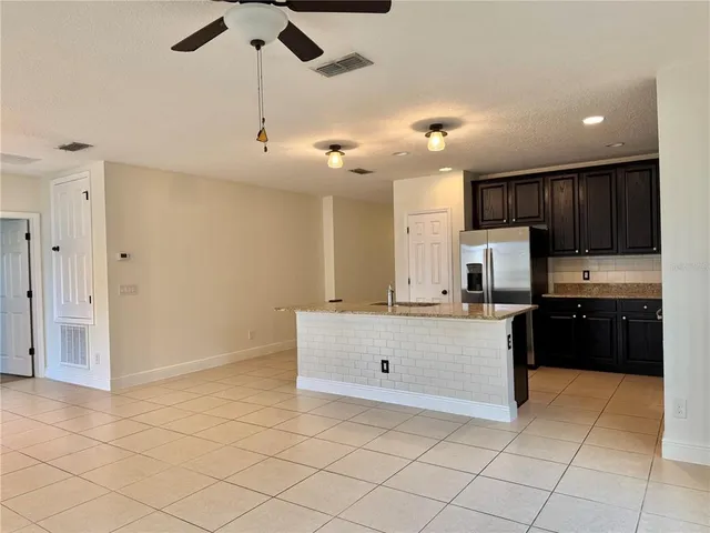 a view of a house with backyard and garden