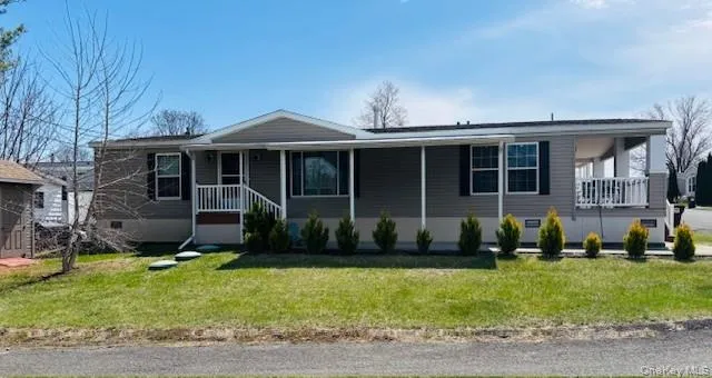 a view of a house with a yard and plants